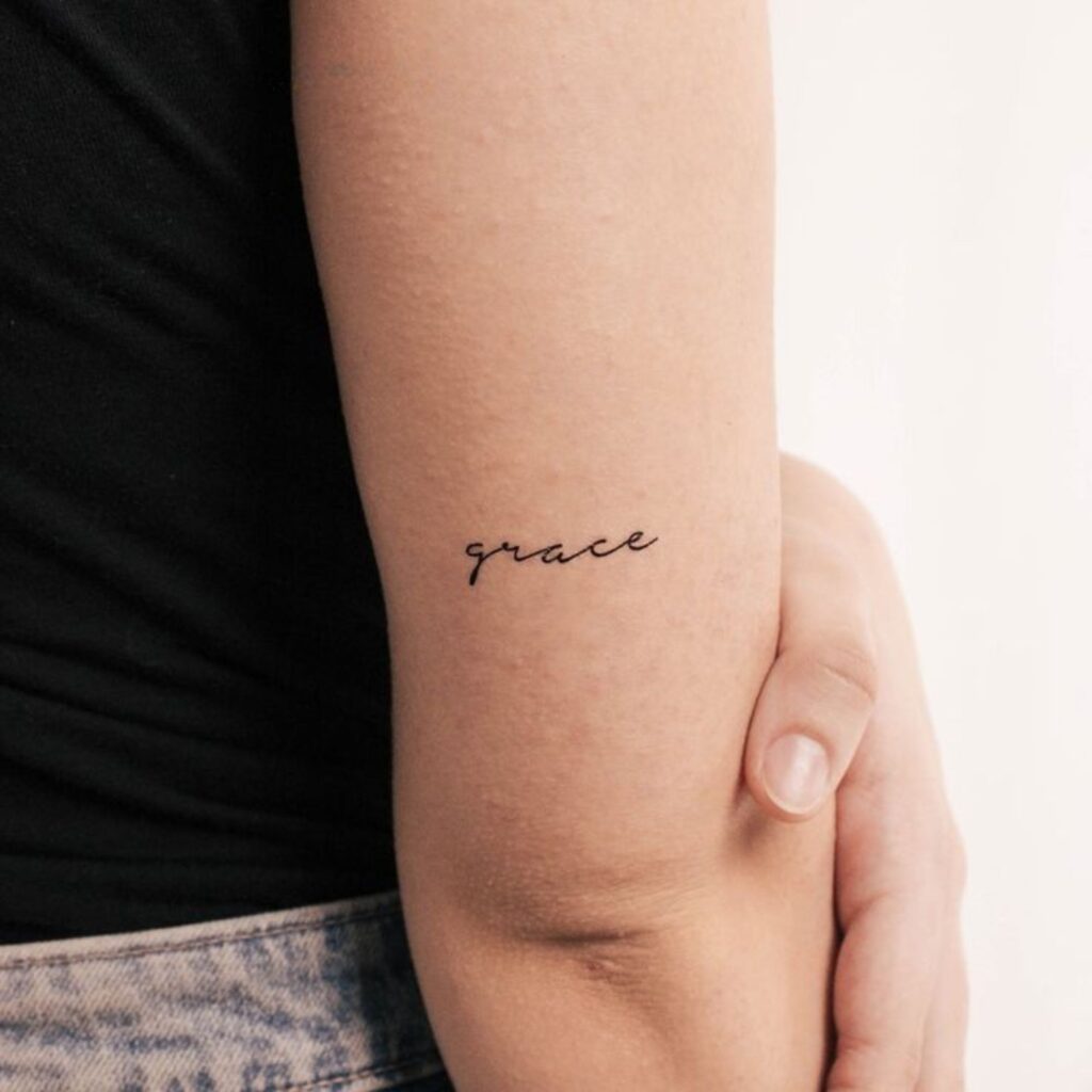 The word “Grace” is engraved on the biceps
