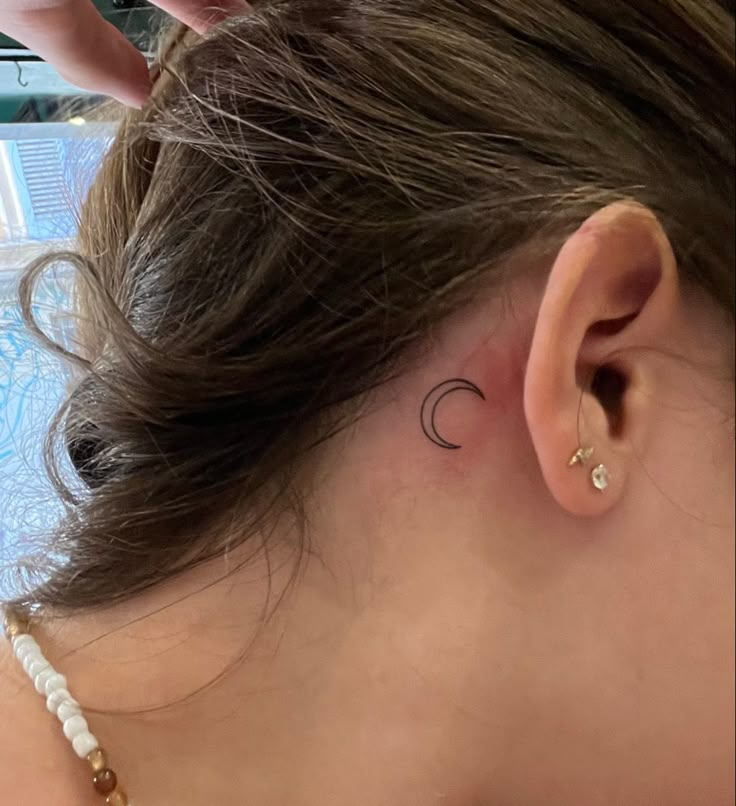 Crescent moon behind the ear