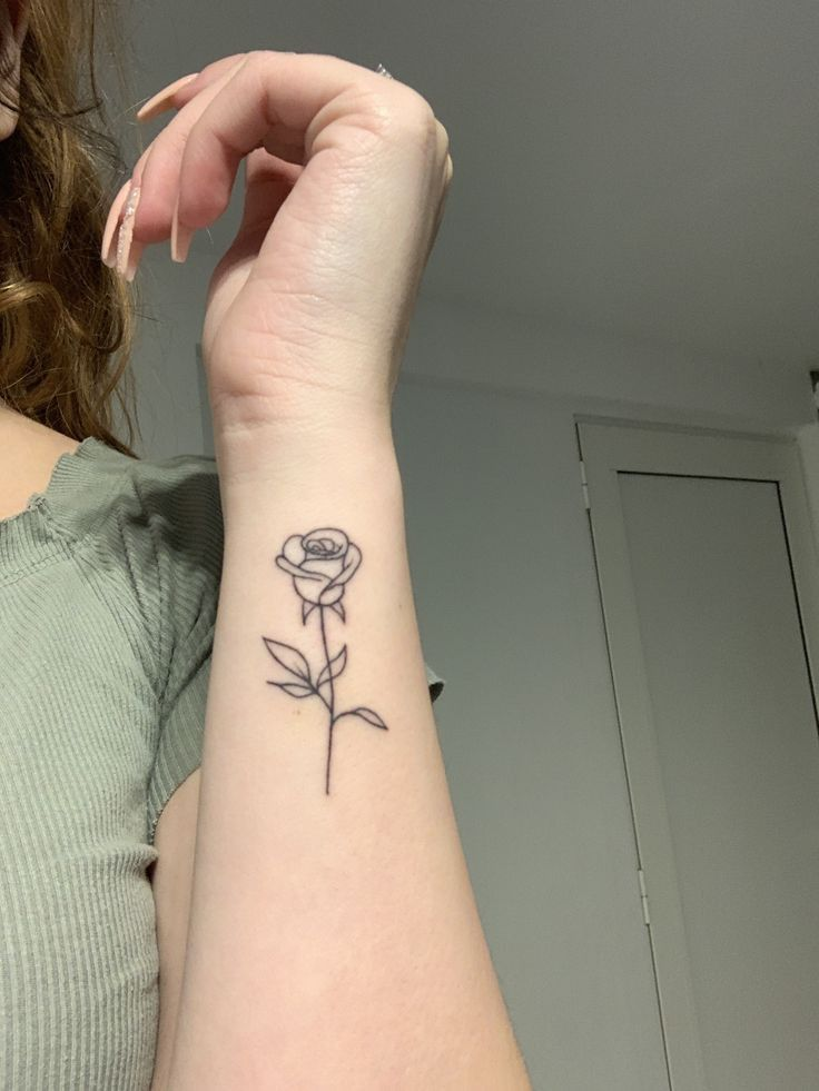 A tiny rosebud on the side of the wrist